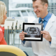 Dentist showing his patient an xray image from adstra imaging on an iPad