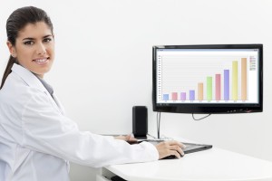 Dental hygenist working on a computer with dental charting software
