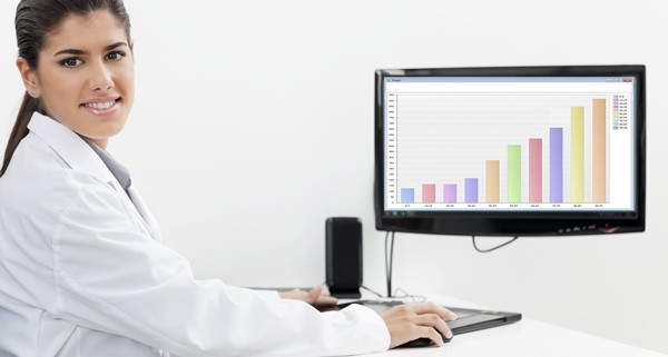 Dental hygenist working on a computer with dental charting software