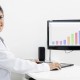 Dental hygenist working on a computer with dental charting software